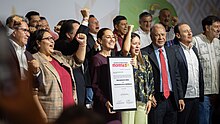 Sheinbaum receiving a certificate confirming her as the presidential nominee for Sigamos Haciendo Historia on 19 November 2023. Claudia Sheinbaum precandidata presidencial.jpg