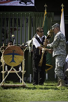 David Gipp, president of United Tribes Technical College, presents a bow and arrow to Army Maj. Gen. David Sprynczynatyk during the UH-72A Lakota dedication ceremony Dr. David Gipp, president of United Tribes Technical College, presents a bow and arrow to Army Maj. Gen. David Sprynczynatyk, adjutant general for the North Dakota National Guard, during the UH-72A Lakota 120904-A-SL271-012.jpg