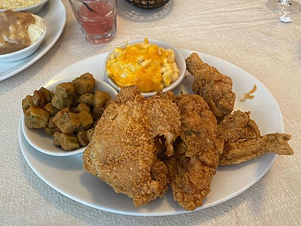 Fried chicken with side dishes, fried okra, and macaroni and cheese
