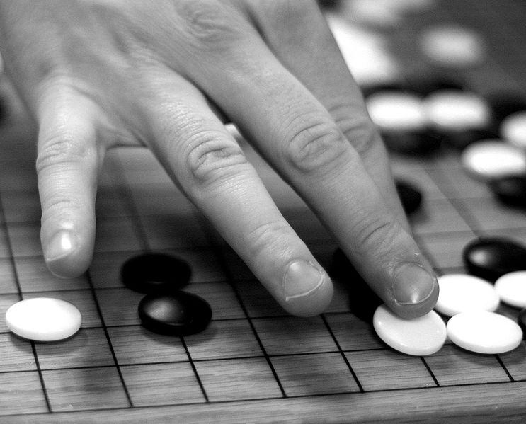 File:Game of go - placing a white stone.jpg