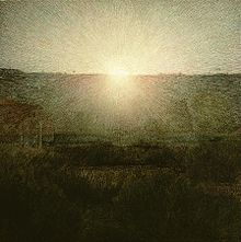 Bright sun rising over a landscape