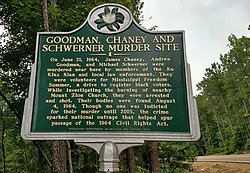 State of Mississippi roadside marker denoting the location where the 1964 murders of American civil rights workers Goodman, Chaney, and Schwerner took place Goodman Cheney and Schwerner Murder Site Marker.jpg