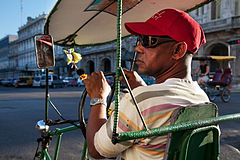 Street life: A "Bicitaxi" driver awaiting customers. Havana (La Habana), Cuba