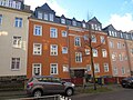 Apartment building in closed development with front garden and fence