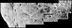 Surface of Hyperion with several craters full of a mysterious reddish gunk. The material contains long chains of carbon and hydrogen and appears very similar to material found on other Saturnian satellites, most notably Iapetus. Hyperion surface.jpg