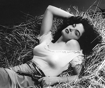 Jane Russell in The Outlaw (1943). Director Howard Hughes' overemphasizing of her cleavage prompted the MPAA to take actions against the film and make the first use of the term cleavage in association with breasts.[1][2][3] Hughes and Russell are considered pioneers of exaggerated cleavage in movies.[4] For the film, Hughes designed a prototype for an underwire bra to give Russell "five and one-quarter inches" long cleavage.[5]