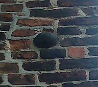 One of several cannonballs still stuck in the walls of St Mary's, Greifswald, from the Brandenburgian siege 1678 Kanonenkugel Greifswald.JPG