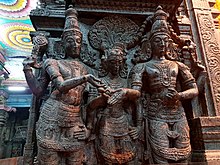Vishnu (left) gives away his sister and bride Meenakshi's hand into the waiting hand of groom Shiva. Mariage of Shiva and Parvati (Meenakshi) witnessed by Vishnu, Meenakshi Temple, Madurai (2) (36857653813).jpg