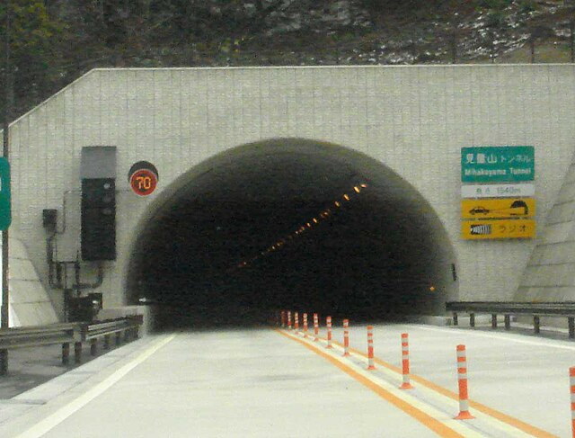 A typical tunnel entrance for rural two-lane expressways with electronic speed limit and notice signs