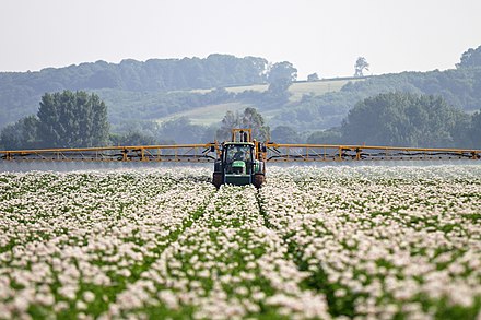 Spraying in a potato field for prevention of potato blight in Nottinghamshire, England.
