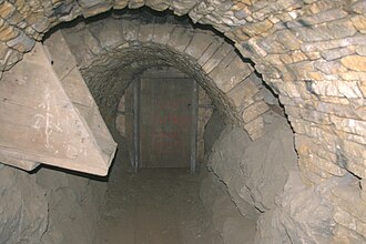 Door for directing ventilation in an old lead mine. The ore hopper at the front is not part of the ventilation. Smallcleugh door.jpg