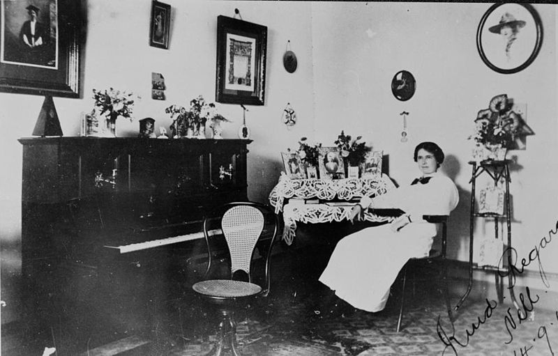 File:StateLibQld 1 50804 Nell sitting at her writing desk in the living room, Queensland, 1915.jpg