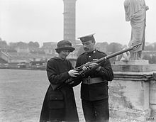 A recruit to the Women's Royal Naval Service learning the parts of a rifle from a Royal Marine at the Crystal Palace depot. The Women's Royal Naval Service on the Home Front, 1917-1918 Q18898.jpg