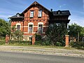 Villa with enclosure and retaining walls