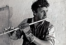 A craftsman takes a break and plays his flute. Tvarflojt - 1987.jpg