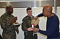 US Navy 120213-N-RL694-002 Montel Williams, a former enlisted Marine and graduate of the U.S. Naval Academy, serves two Marines a green shake he pr.jpg