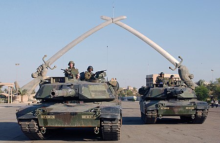 M1A1 Abrams pose for a photo under the "Hands of Victory" in Ceremony Square, Baghdad, Iraq. UStanks baghdad 2003.JPEG