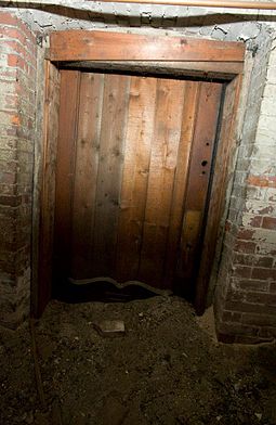 Door to a compartment where runaway slaves would sleep, on the Underground Railroad Underground Railroad Tunnel Door.jpg