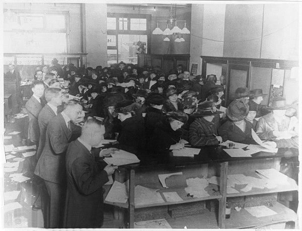 People filing tax forms in 1920.