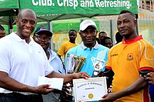 Mr. Herbert Mensah presenting a certificate of achievement and the winner's trophy of the 2016 Ghana Rugby Club Championship to the winning captain of Conquerors SC. 2016 Ghana Rugby Club Championship Final.jpg