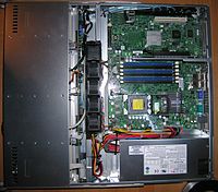 Supermicro 5016T-MTFB (1U server). CPU and memory slots are empty; also contains one (topmost) dummy fan that can be replaced by functional fan if required. While blue SATA cables to hard drives are installed (top edge), hard drives themselves are not included. The available PCI-Express slot (riser card in the middle) is also empty. Includes motherboard, CD-ROM and power supply (bottom). Old PCI slot is still present on the motherboard but requires separately sold riser card to be reachable. 5016T-MTFB.jpg