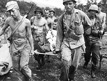 Troops of the 511th Parachute Infantry Regiment evacuate a wounded soldier to an aid station at Manarawat on the island of Leyte, December 1944.