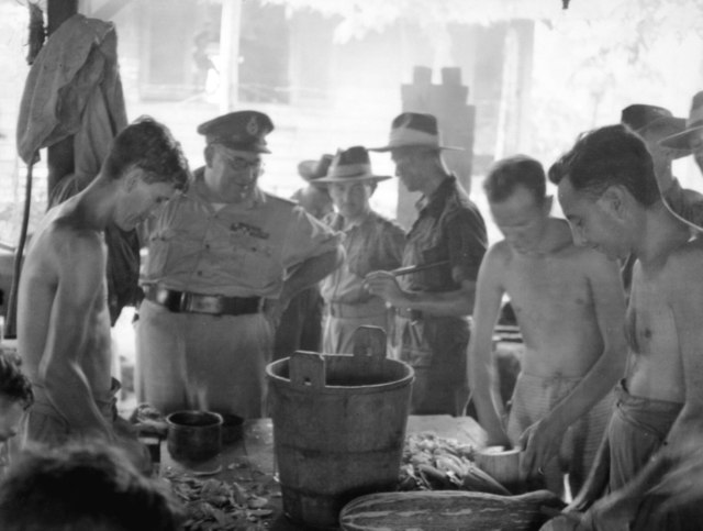 Major General Wootten (second left) with Australian ex-POWs at Batu Lintang POW/internment camp, Kuching, Sarawak, 12 September 1945.