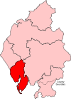 A small constituency in the south of the county. It includes a long but very thin island to the west of the mainland part of the constituency.