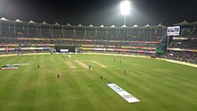 Barsapara Cricket Stadium match under floodlights.jpg