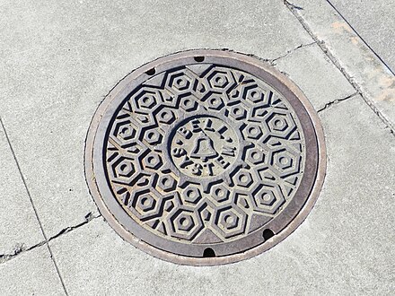 Manhole cover with Bell System logo