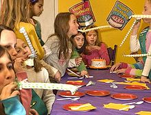 Children blow party horns at a birthday party Birthday party with party horns.JPG