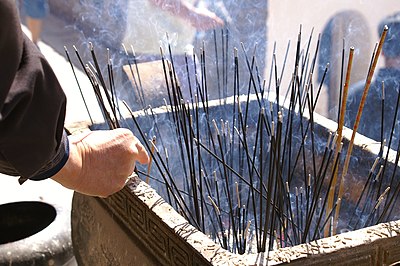Incense sticks being burnt at a Chinese Buddhist place of worship.