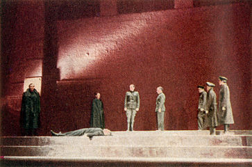 Standing over the murdered body of Caesar, Brutus (Orson Welles) is confronted by Marc Antony (George Coulouris) and Cassius (Martin Gabel) in Caesar
