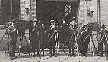 A group of cameramen who worked for the Canadian Government Motion Picture Bureau in 1925. Frank Badgley, the bureau's director from 1927 to 1941, is in the background. Cameramen for the Canadian Government Motion Picture Bureau in 1925.jpg