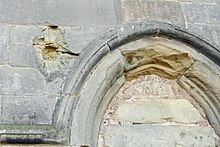 Cannonball damage next to the blocked north doorway Cannonball damage at St Bartholomew's Church, Tong, Shropshire.jpg