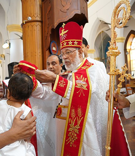 Syro-Malabar Catholic Major Archbishop crowning a baby during chrismation