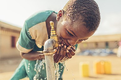 13-year-old student from Malawi now has access to safe water thanks to Water Mission. Dina drinking water.jpg