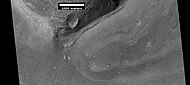 Wide view of a cliff and remains of a glacier, as seen by HiRISE under HiWish program.