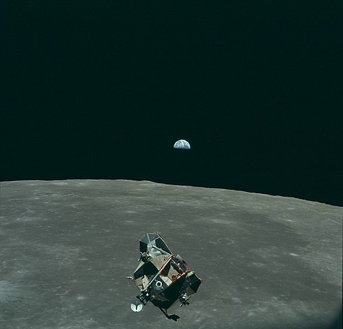 Lunar Module Eagle, the lunar module ascent stage of Apollo 11, in orbit above the Moon. Earth is visible in the distance. Photograph by Michael Colli