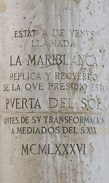 Inscription on the pedestal roughly translates as:  Venus statue called the Mariblanca. Replica and recollection of that which was situated in  the Puerta del Sol before its refurbishment in the mid-19th Century - (dated: 1986)