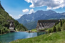 The ruins of the dam in 2019, with the new, smaller dam bridging the gap left by the collapse Gleno 1.jpg