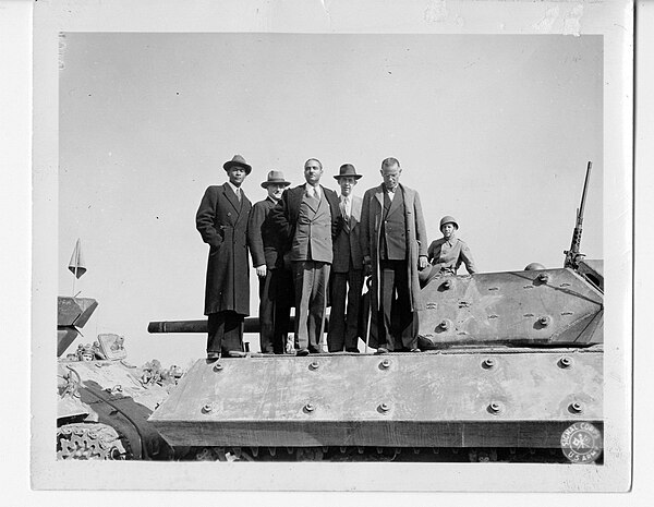 Haitian newspaper reporters with a tank from the 608th Tank Destroyer Battalion.