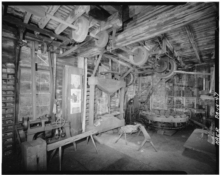 File:June 1974. BLACKSMITH SHOP, VIEW LOOKING SOUTHWEST, SHOWING THE LINESHAFT ALONG THE SOUTH WALL. MACHINES SHOWN (LEFT TO RIGHT)- WELLS BROS. and CO. BOLT THREADER, DEFIANCE HAER PA,6-BERN.V,8-47.tif