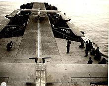 USS LST-906, with US Army Air Force L-4 Grasshopper on her flight deck being prepared for take-off. Note additional L-4 type aircraft stowed alongside the deck. LST Aircraft Carrier.jpg