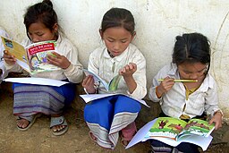 Lao schoolgirls reading books
