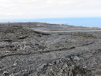 Lavafeld des Llano del Banco-Vulkans, im Hintergrund das Meer