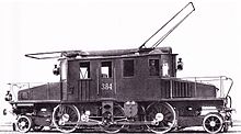 Photograph of an Italian centre-cab electric locomotive with large overhead bow collectors for the two-wire three-phase system