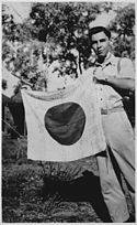 Lt. Woody J. Cochran holding a Japanese flag, New Guinea, 04-01-1943 - NARA - 519155.jpg