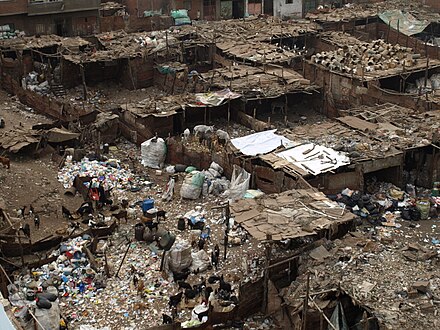 Shanty towns sometimes have an active informal economy, such as garbage sorting, pottery making, textiles, and leather works. This allows the poor to earn an income. The above shanty town image is from Ezbet Al Nakhl, in Cairo, Egypt, where garbage is sorted manually. Residential area is visible at the top of the image.