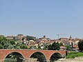 In the foreground the bridge on river Po